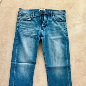 Classic Fit intentionally distressed blue jeans